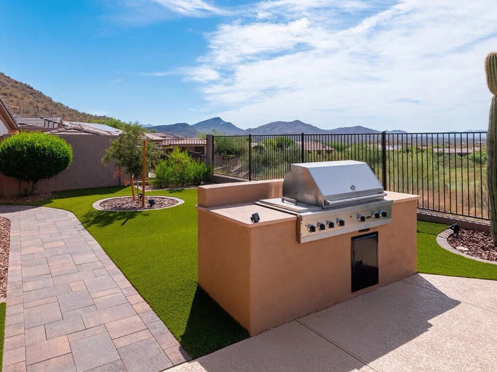 Artificial turf lawn with built in grill and desert mountain backdrop